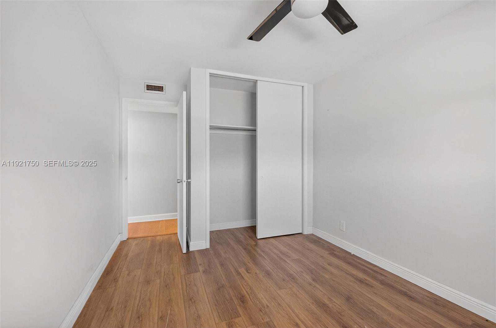 371 Southwest 8th Street, Unit 2C Boca Raton, FL 33432 - Photo 10 of 13 wooden floor in an empty room