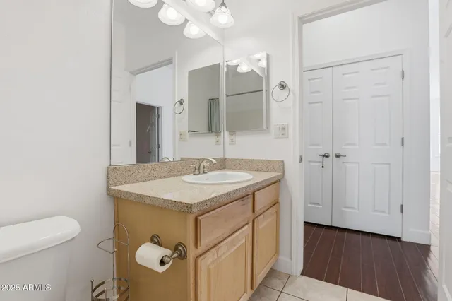 a bathroom with a sink a toilet and mirror