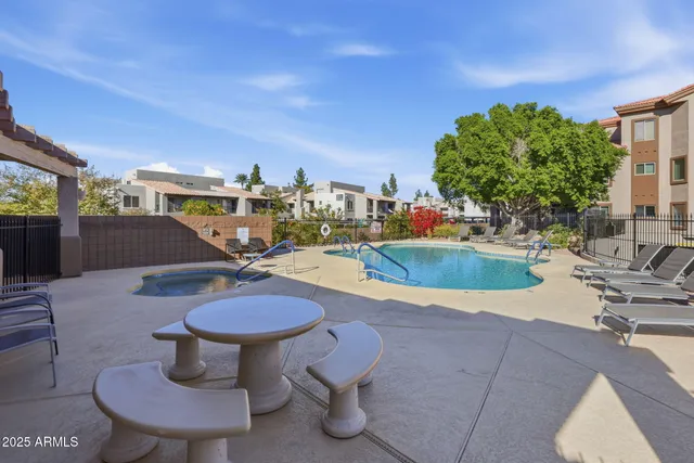 a swimming pool with chairs