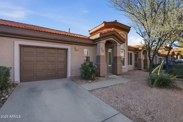 a view of a house with a yard and garage