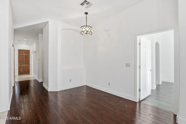 a view of a room with wooden floor