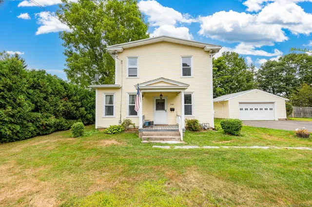 a front view of a house with a yard