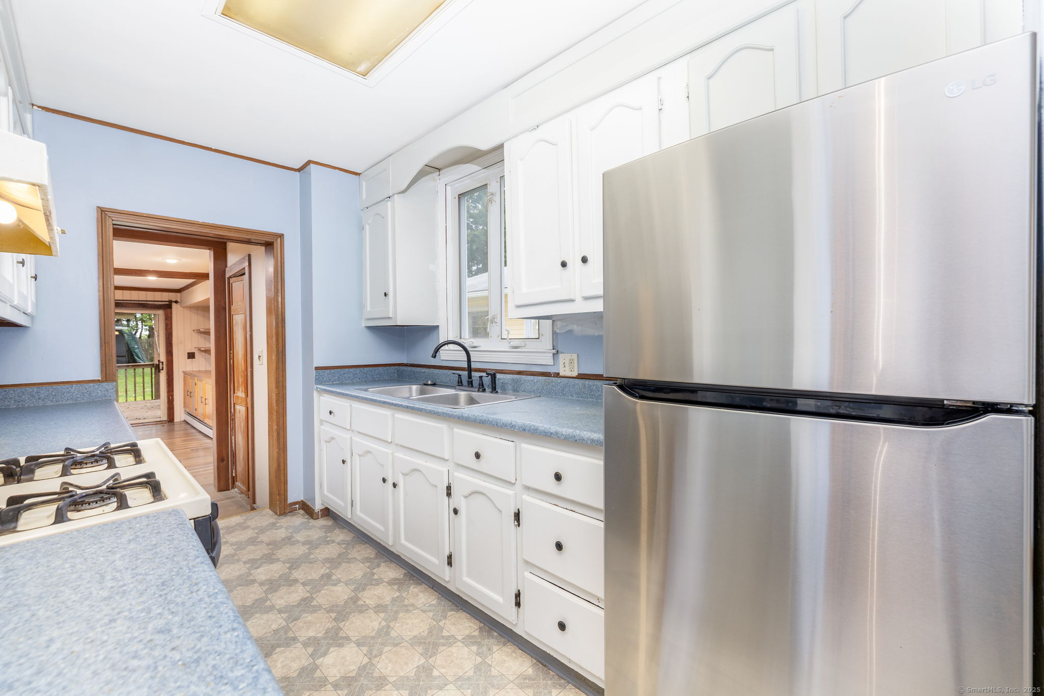 548 Worthington Ridge Berlin, CT 06037 - Photo 14 of 40 a bathroom with a granite countertop sink and a refrigerator