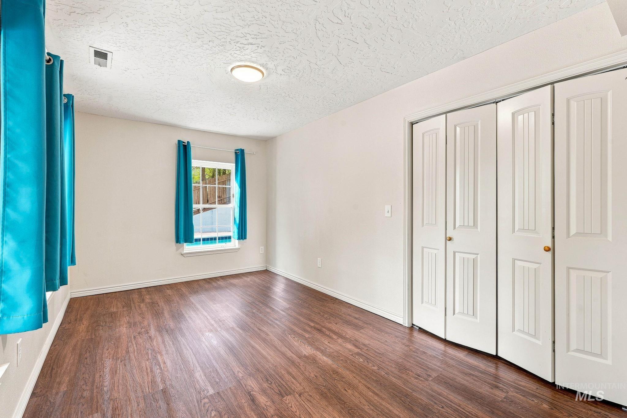 2442 West Hill Road Boise, ID 83702 - Photo 30 of 48 Wood-finish flooring, white walls, and a window with natural light