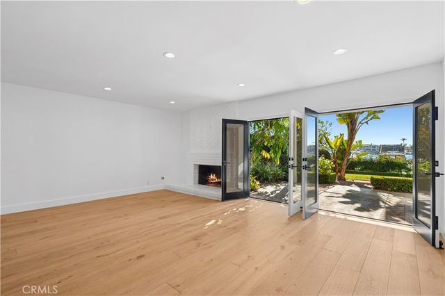 a view of a room with gym equipment and floor to ceiling window