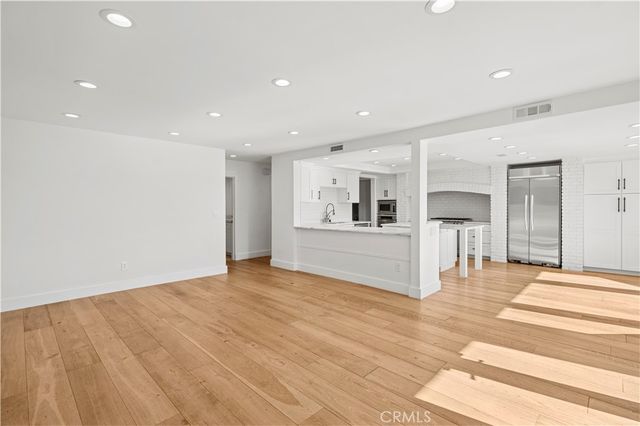 a view of a kitchen with wooden floor and kitchen