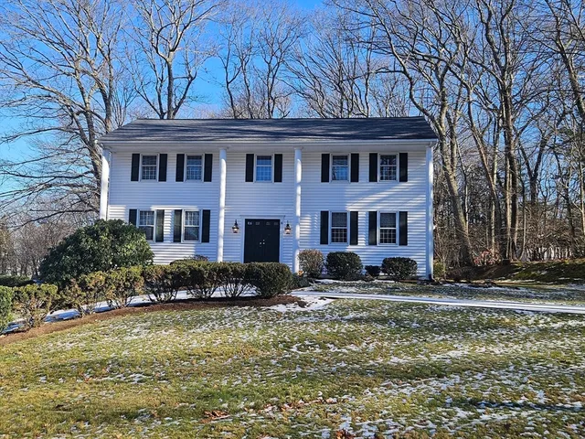 a living room with fireplace furniture and a wooden floor