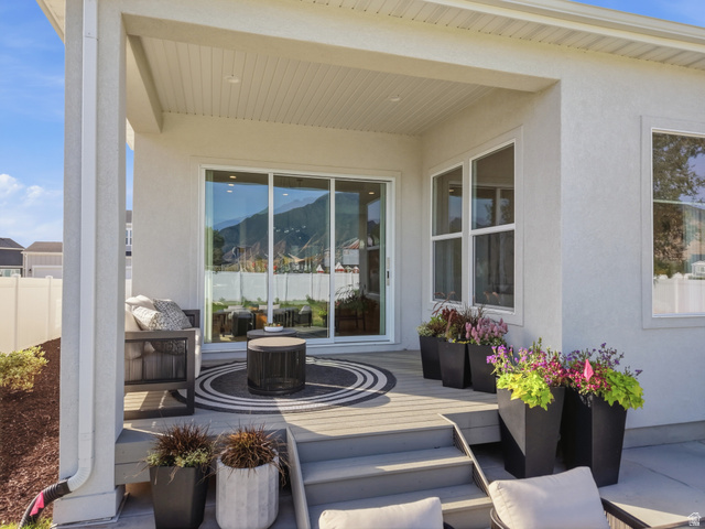 2559 West Aurora Avenue Mapleton, UT 84664 - Photo 56 of 60 Covered patio featuring a wood-finish deck, multi-pane windows, sliding glass door, recessed lighting, and a stucco exterior
