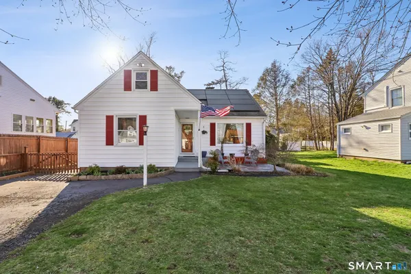 a front view of a house with a garden