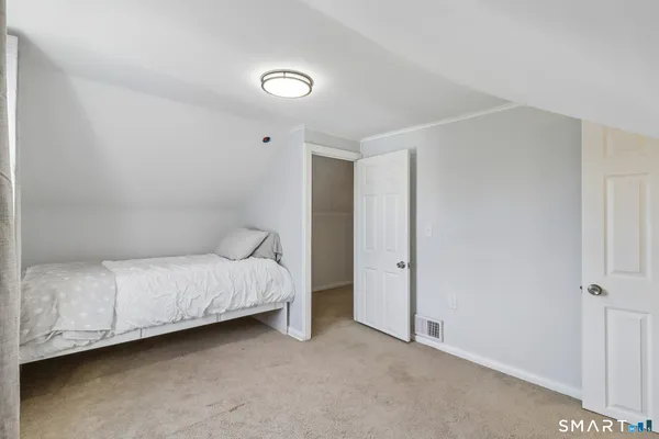 a bed room with a bed and a chair
