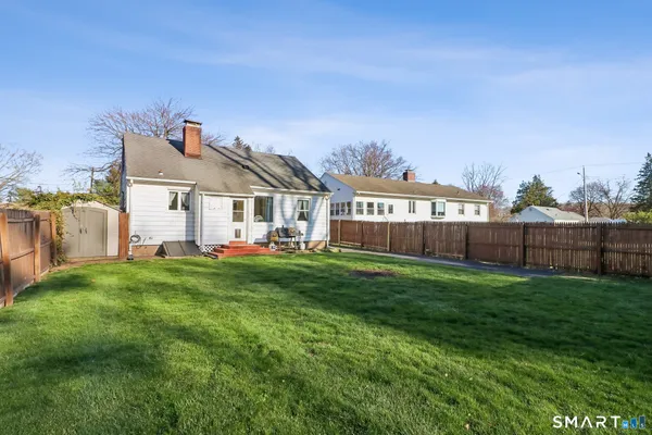 a front view of a house with yard and porch