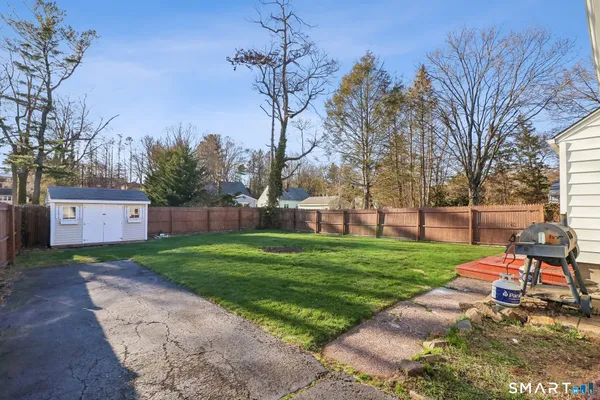 a view of a backyard with a garden and trees