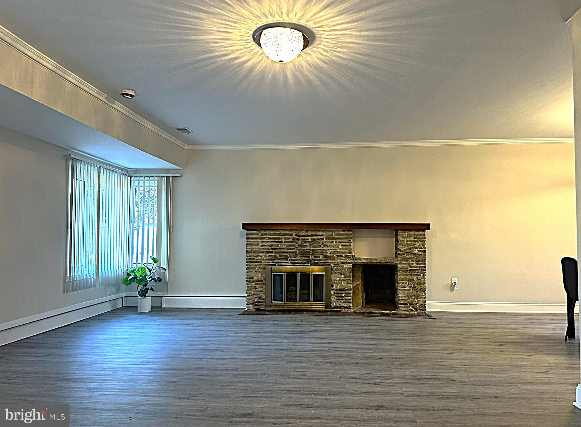 4121 Villa Nova Road Baltimore, MD 21207 - Photo 13 of 57 a view of an empty room with wooden floor and a window