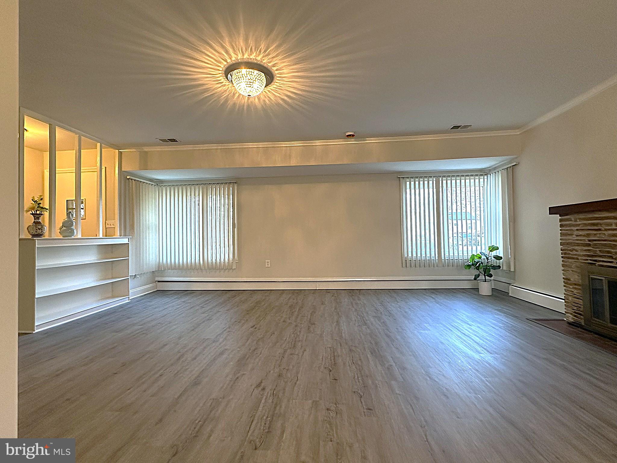4121 Villa Nova Road Baltimore, MD 21207 - Photo 16 of 57 an empty room with wooden floor and windows