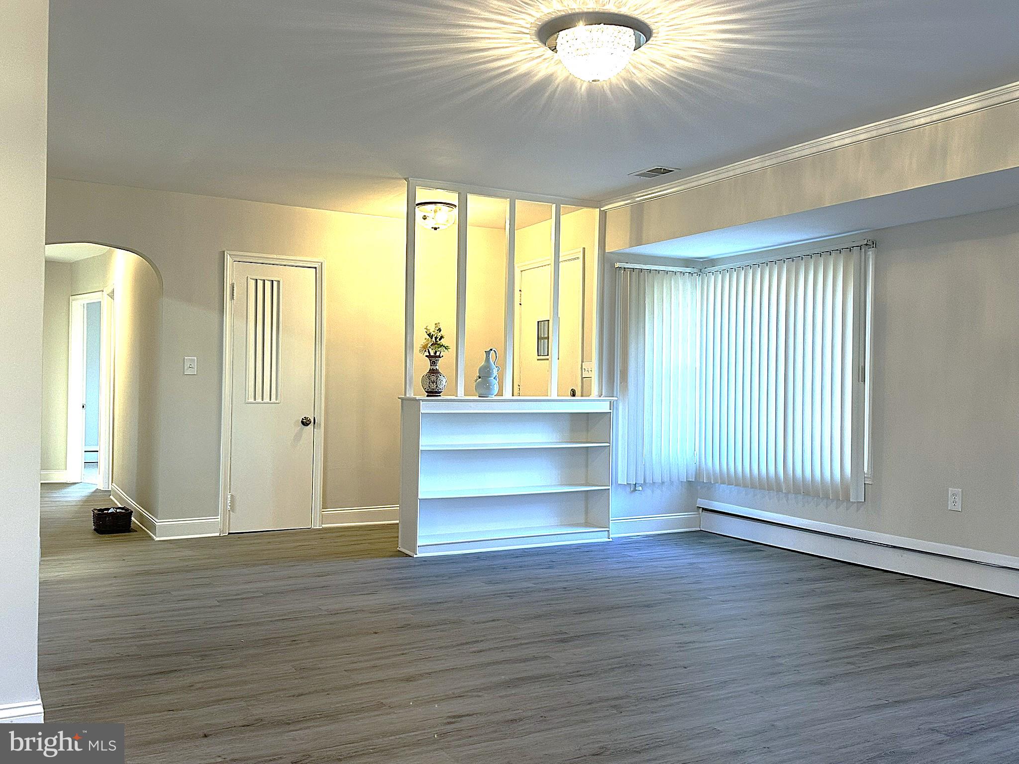 4121 Villa Nova Road Baltimore, MD 21207 - Photo 20 of 57 an empty room with wooden floor and windows