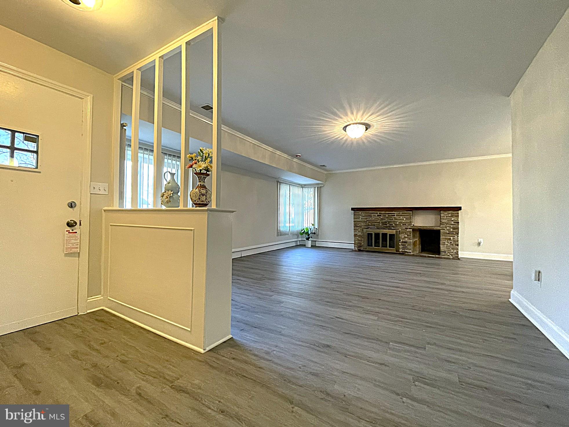4121 Villa Nova Road Baltimore, MD 21207 - Photo 21 of 57 a view of a livingroom with wooden floor and a fireplace