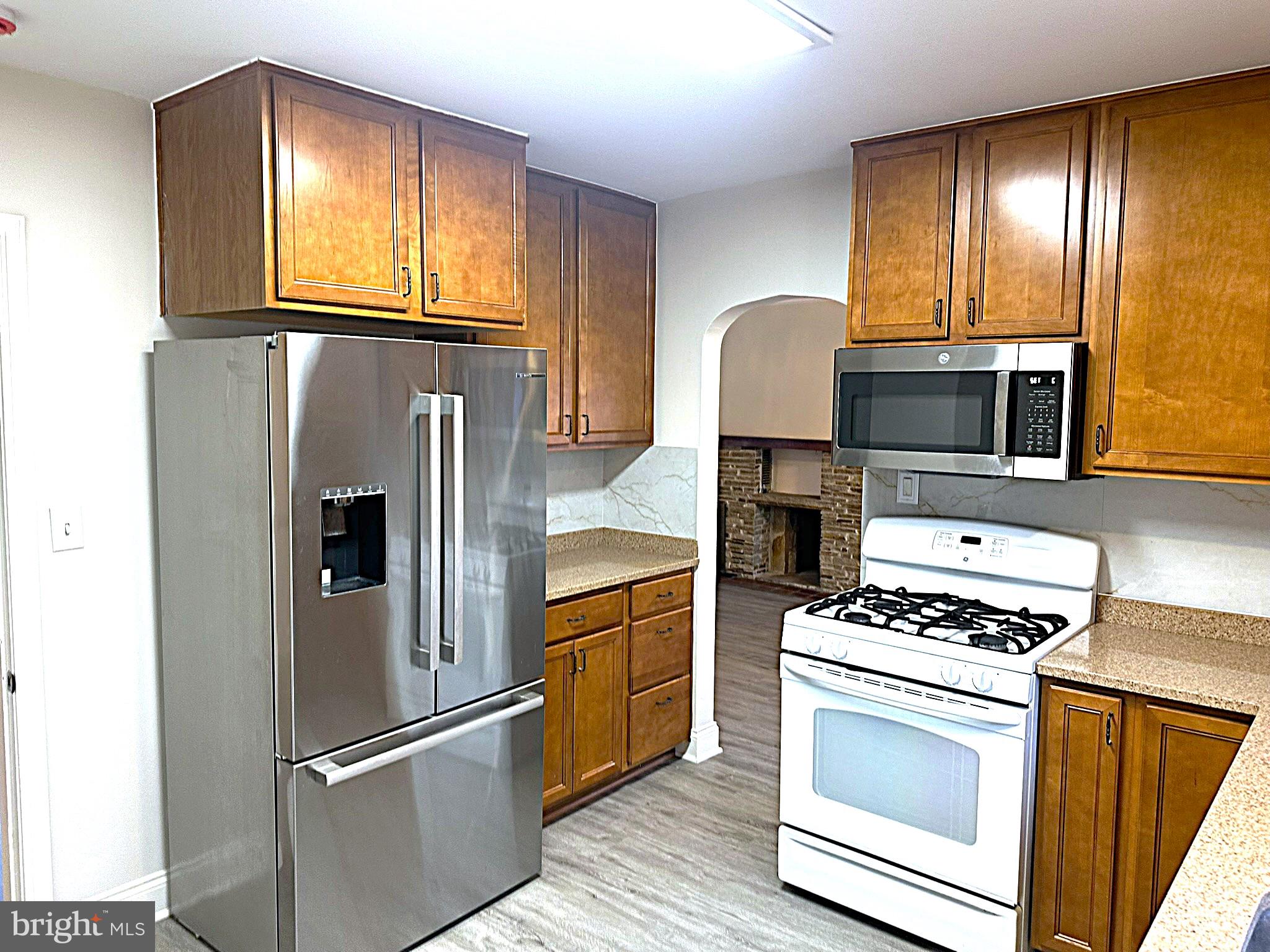 4121 Villa Nova Road Baltimore, MD 21207 - Photo 25 of 57 a kitchen with granite countertop a stove and a refrigerator