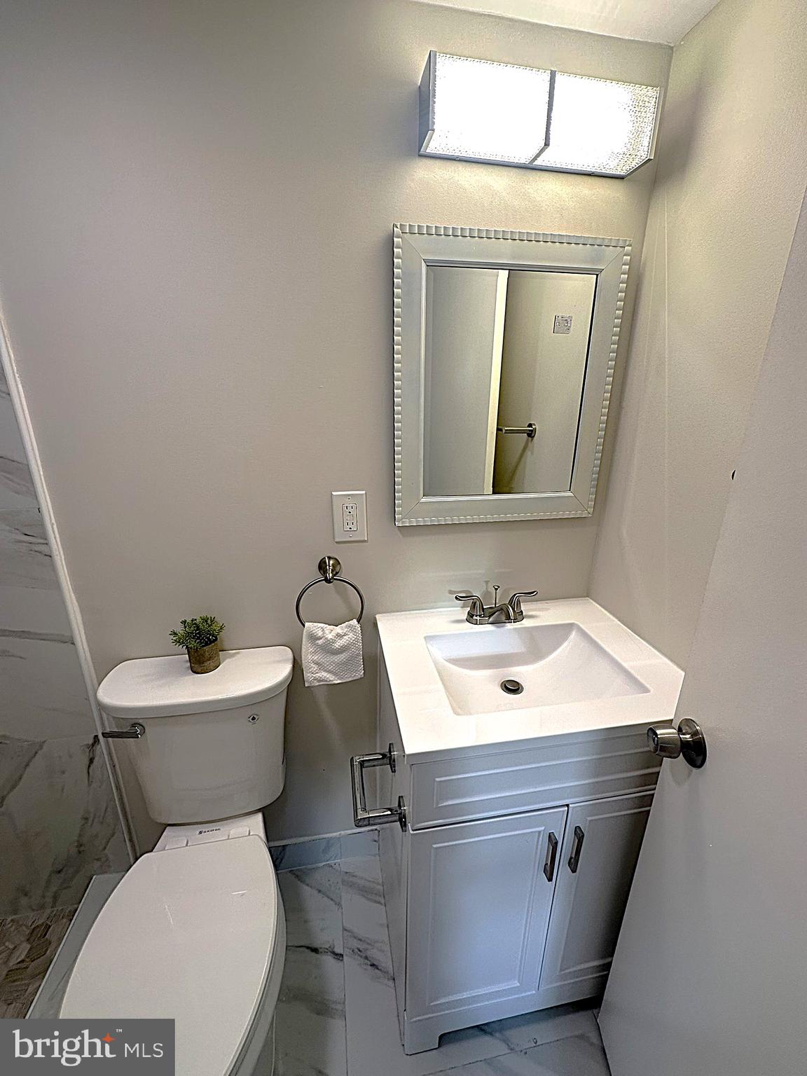 4121 Villa Nova Road Baltimore, MD 21207 - Photo 39 of 57 a bathroom with a toilet sink vanity and mirror