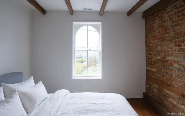 a bedroom with a bed and a window