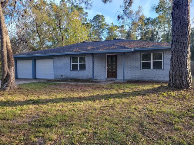 a house that has a tree in front of it