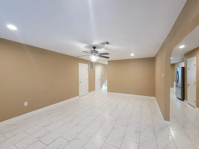 a view of a livingroom with a ceiling fan and window