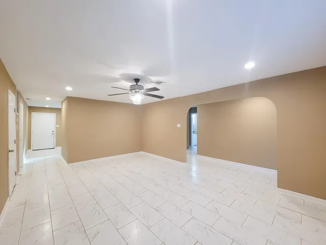 a view of an empty room with a fan