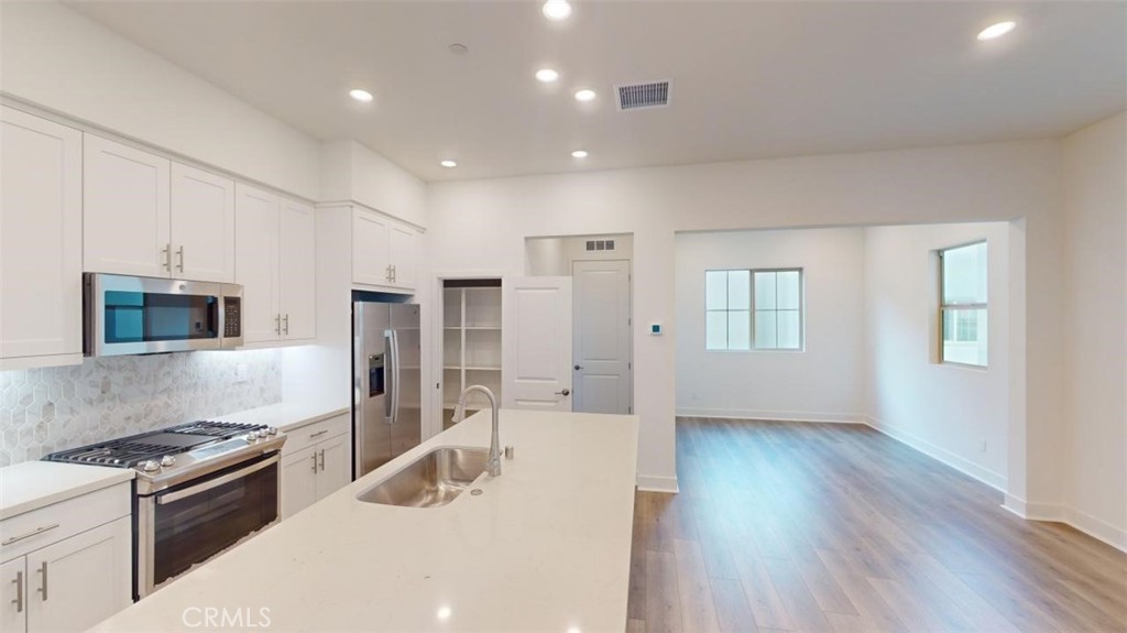 1689 Intrepid Lane San Pedro, CA 90732 - Photo 11 of 51 a kitchen with stainless steel appliances granite countertop a stove a sink and a refrigerator