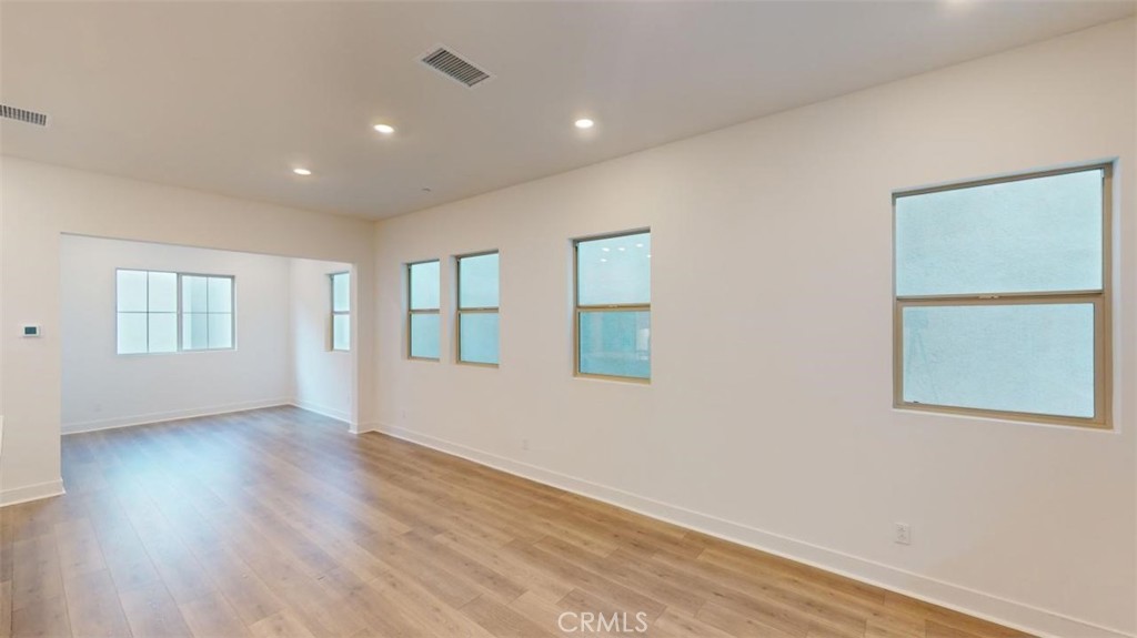 1689 Intrepid Lane San Pedro, CA 90732 - Photo 12 of 51 a view of an empty room with wooden floor and a window