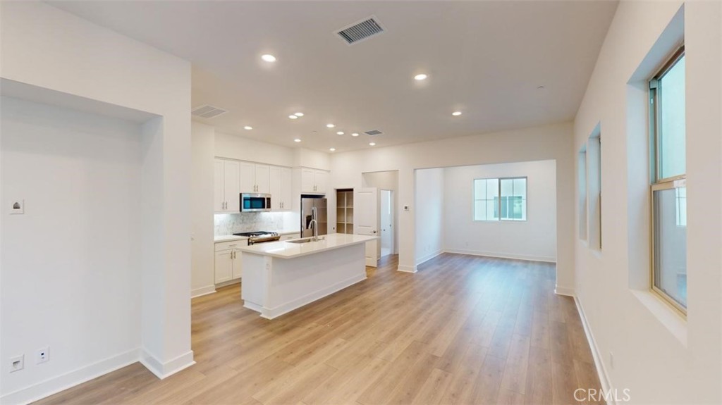 1689 Intrepid Lane San Pedro, CA 90732 - Photo 13 of 51 a view of kitchen with wooden floor electronic appliances and window