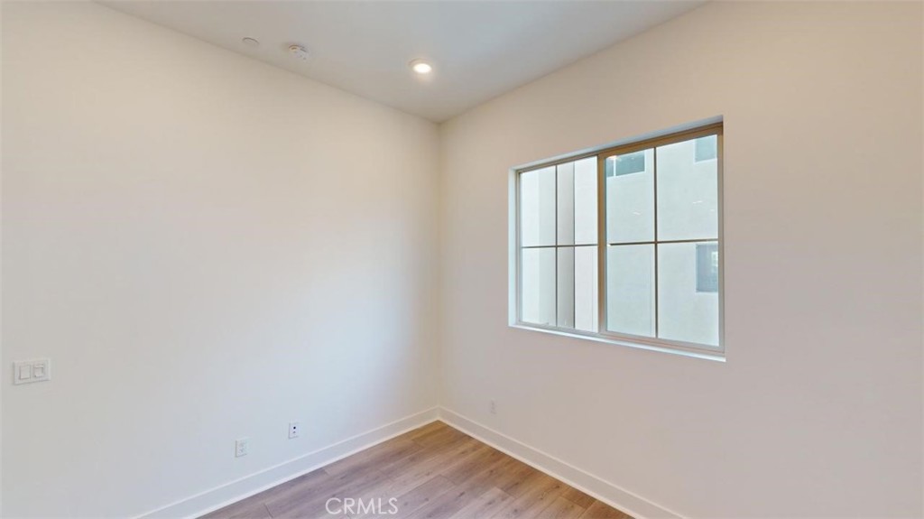1689 Intrepid Lane San Pedro, CA 90732 - Photo 15 of 51 a view of an empty room with wooden floor and a window