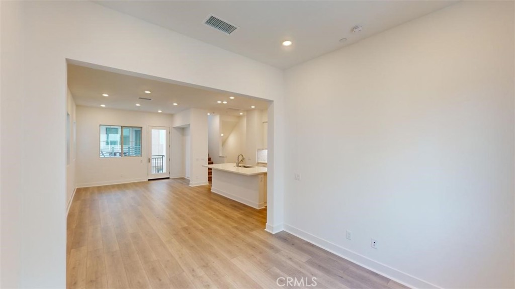 1689 Intrepid Lane San Pedro, CA 90732 - Photo 16 of 51 a view of a hallway with wooden floor and a kitchen