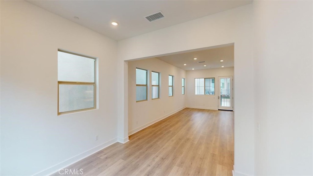 1689 Intrepid Lane San Pedro, CA 90732 - Photo 17 of 51 an empty room with wooden floor and windows