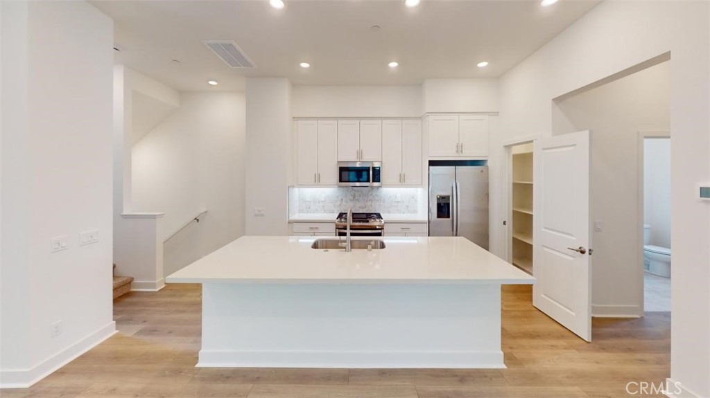 1689 Intrepid Lane San Pedro, CA 90732 - Photo 2 of 51 a large kitchen with stainless steel appliances a large counter top a refrigerator and a sink