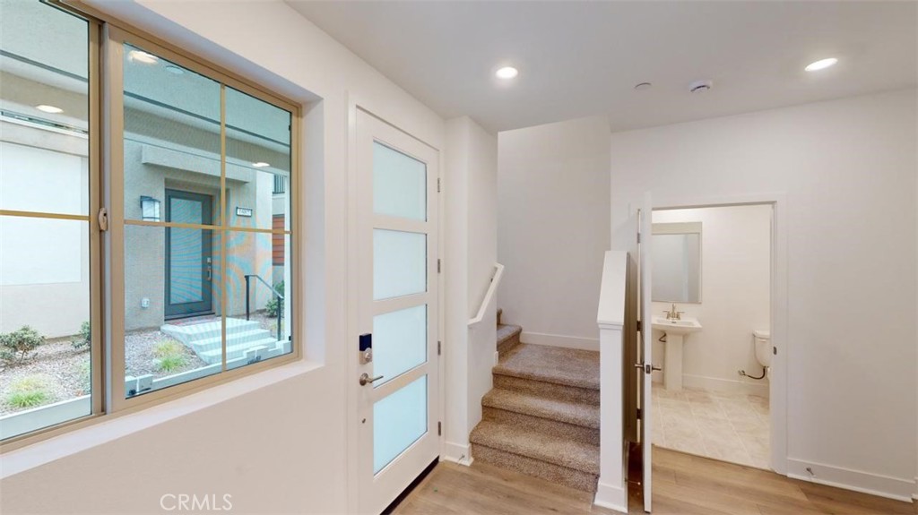 1689 Intrepid Lane San Pedro, CA 90732 - Photo 4 of 51 a view of a hallway with wooden floor and staircase
