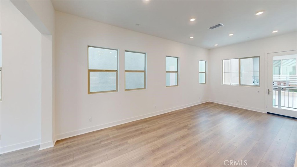 1689 Intrepid Lane San Pedro, CA 90732 - Photo 48 of 51 an empty room with wooden floor and windows