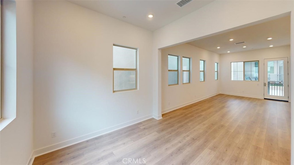 1689 Intrepid Lane San Pedro, CA 90732 - Photo 49 of 51 an empty room with wooden floor and windows