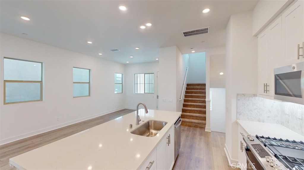 1689 Intrepid Lane San Pedro, CA 90732 - Photo 7 of 51 a bathroom with a sink a mirror and a bathtub
