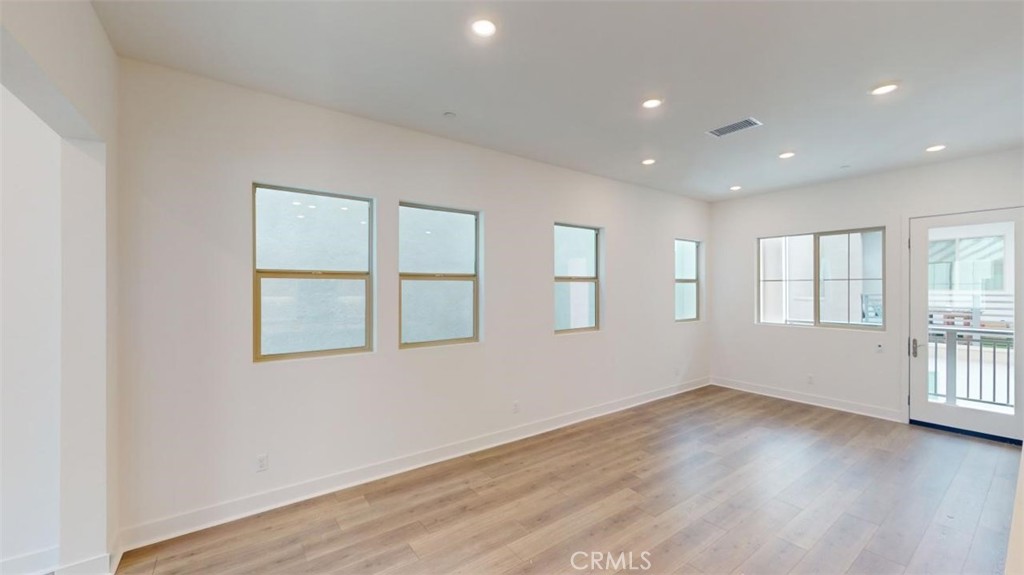 1689 Intrepid Lane San Pedro, CA 90732 - Photo 9 of 51 an empty room with wooden floor and windows