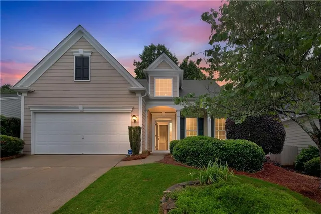 a front view of a house with a yard and garage