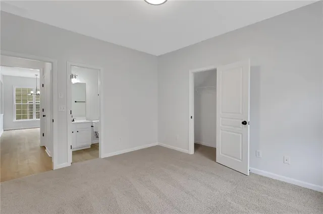 a view of a big room with wooden floor and windows