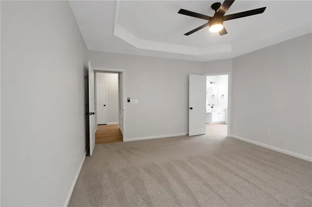 a view of a livingroom with a ceiling fan and window