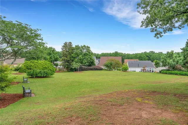 a view of a room with a large window and wooden floor