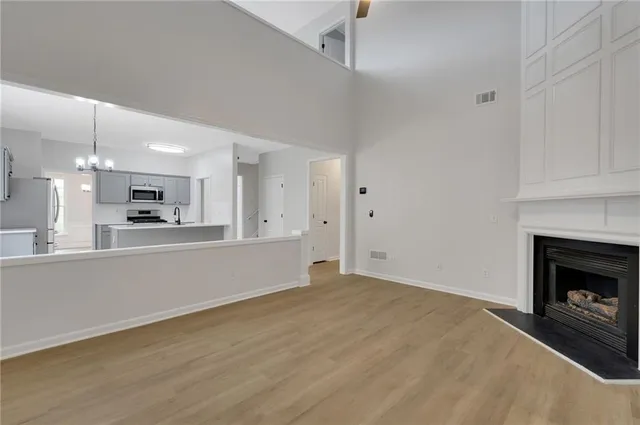 a view of a kitchen with a sink and a fireplace