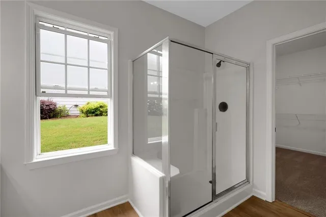 a spacious bathroom with a double vanity sink a mirror and a bathtub