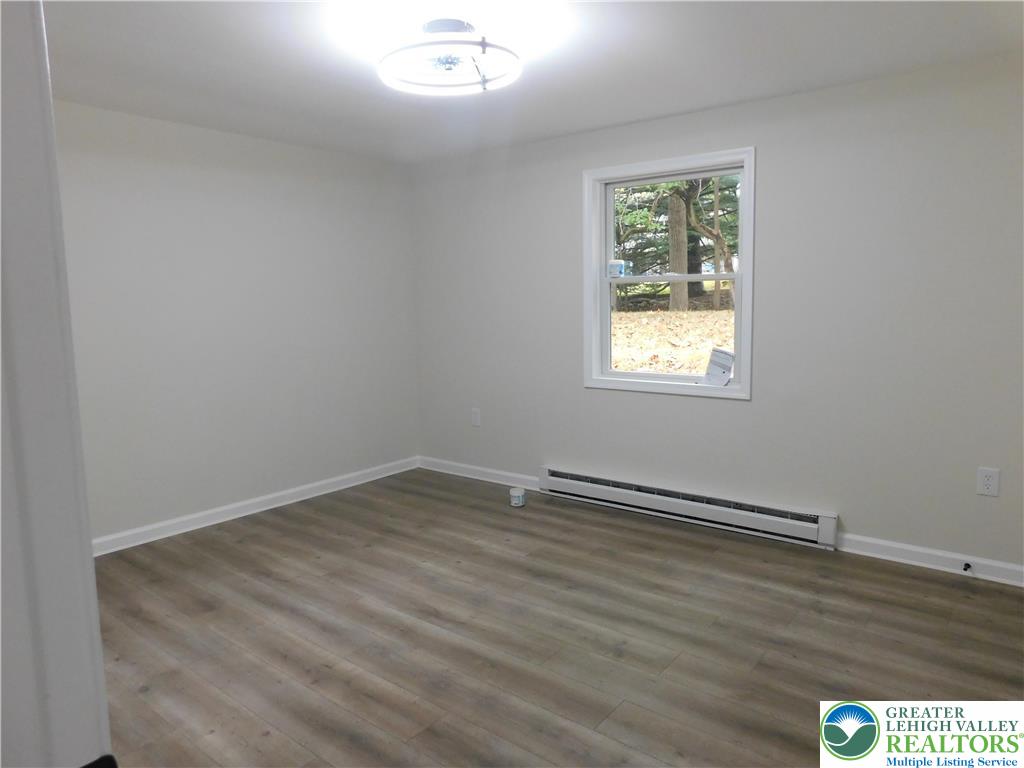 1405 Donalds Road Effort, PA 18330 - Photo 24 of 31 an empty room with wooden floor and windows