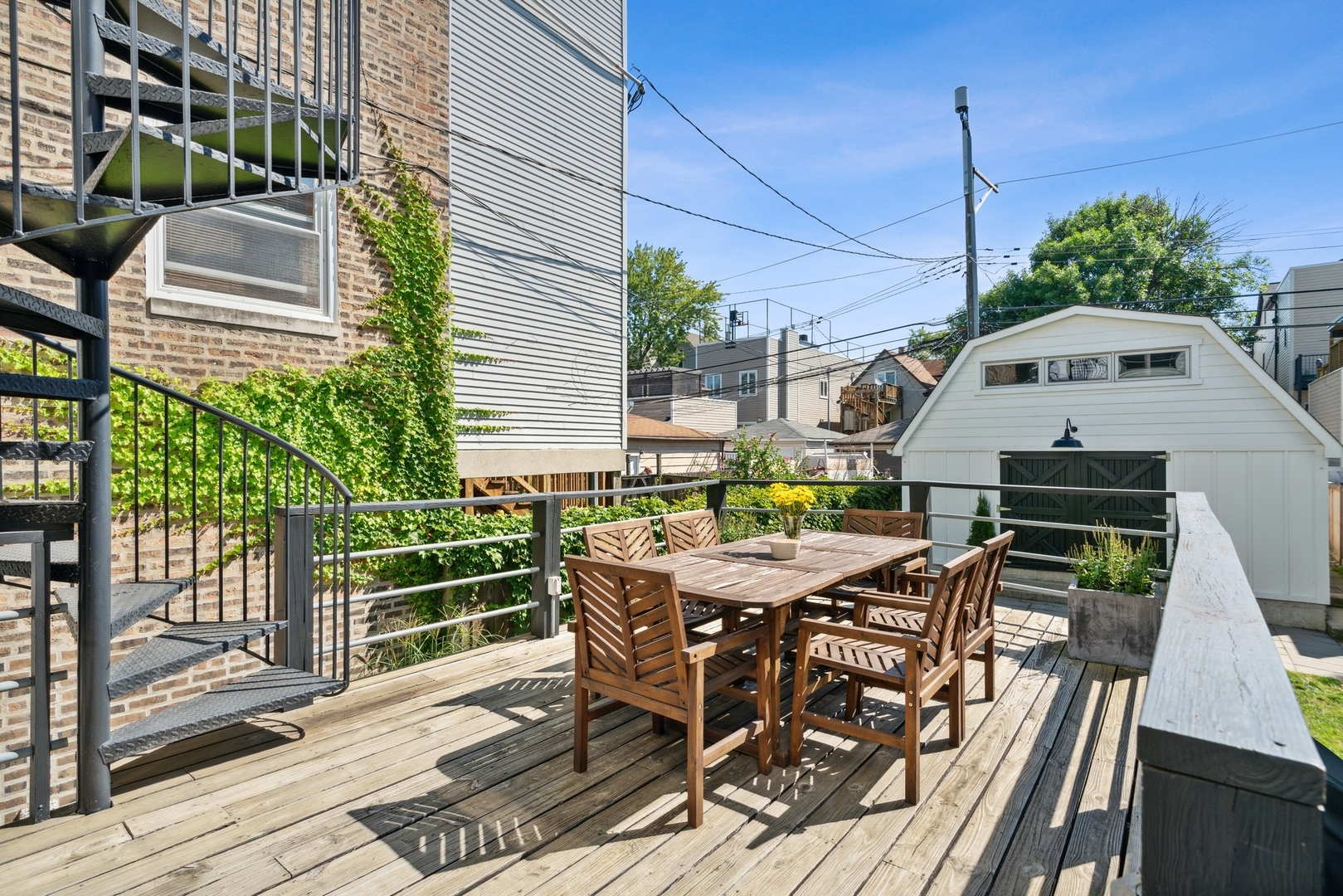 3317 North Bell Avenue Chicago, IL 60618 - Photo 12 of 30 a view of a roof deck with table and chairs and potted plants