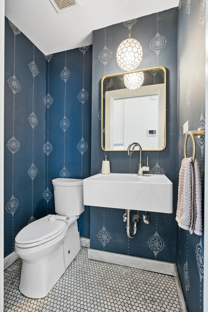 3317 North Bell Avenue Chicago, IL 60618 - Photo 15 of 30 a bathroom with a sink vanity granite toilet and a mirror