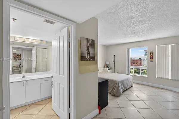 a spacious bedroom with a bed and a cabinets