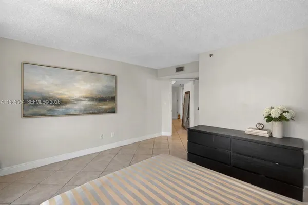 a living room with a bed and a painting on the wall