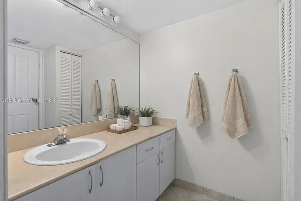 a bathroom with a double vanity sink and a mirror